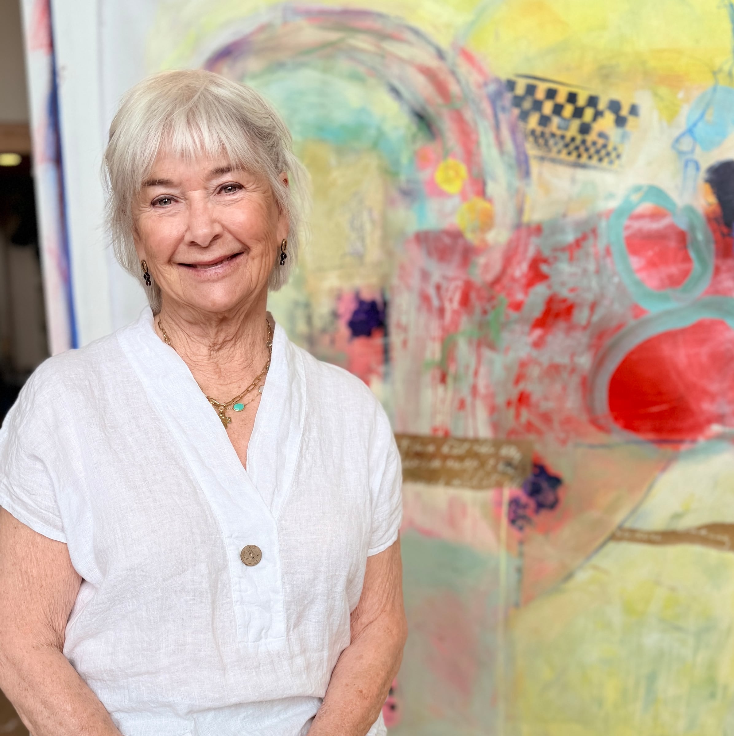 Nancy Junkin in front of a colorful painting